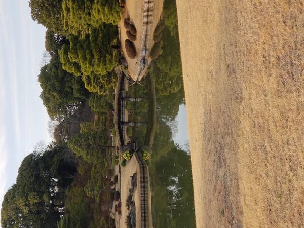 Tranquil scene in Rikugien gardens of a bridge over a lake, with a nice reflection of the bridge too